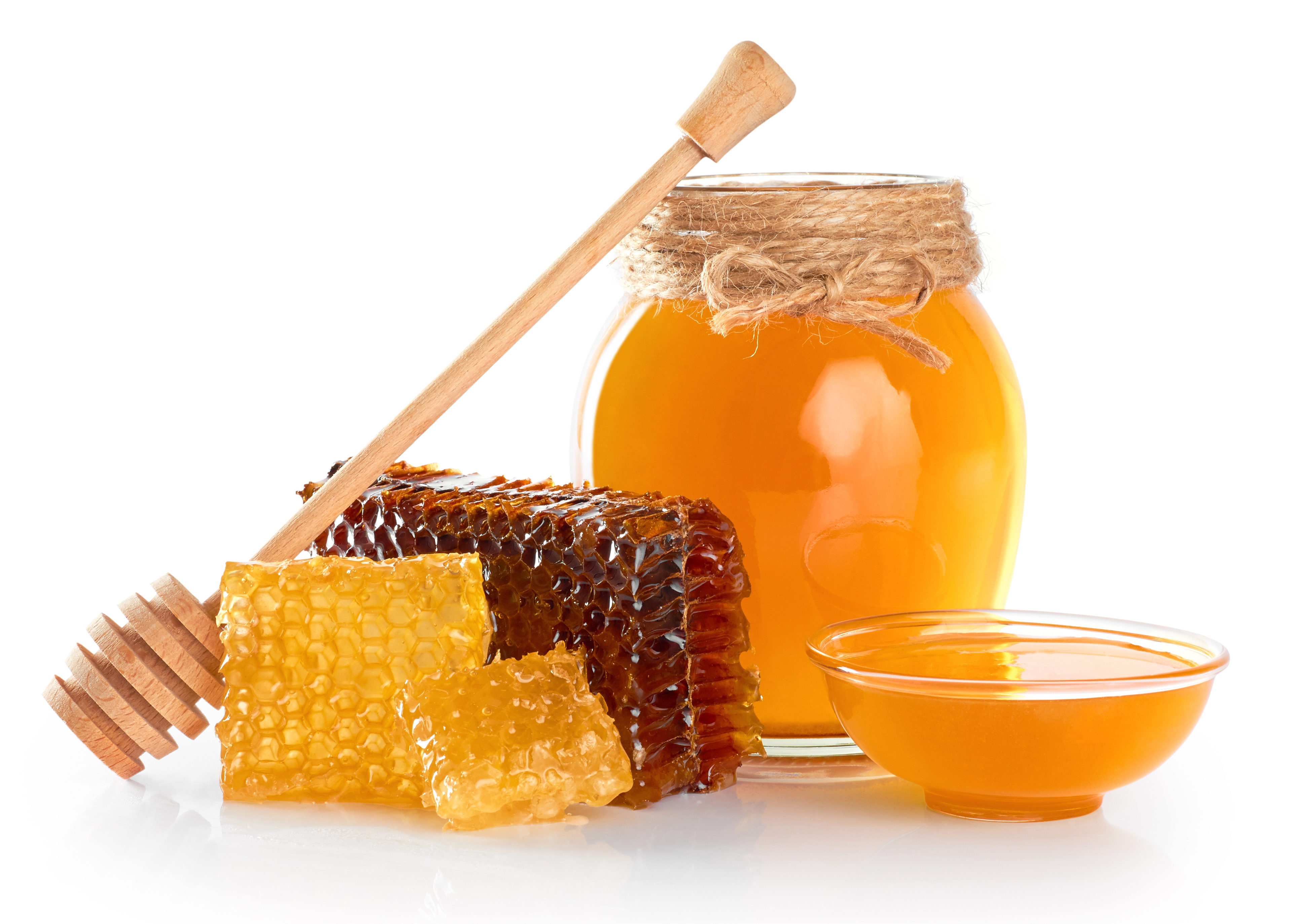 Fresh honey with honeycomb isolated on white background. Honey dipper.